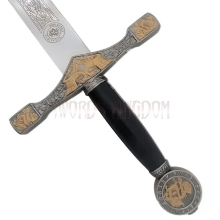 Close-up of King Arthur's Excalibur replica handle and pommel with black grip, engraved fittings, and medieval crest design.