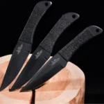 GIL HIBBEN BLACK TRIPLE PRO THROWING KNIFE SET WITH NYLON SHEATH - SOLID PIECE STAINLESS STEEL, BLACK OXIDE COATED - 8 1/2" LENGTH