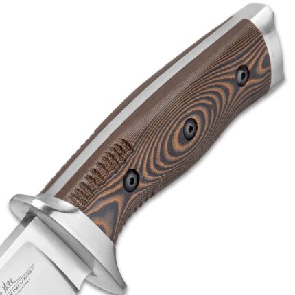 Master knife maker Gil Hibben’s firsthand experience as an Alaskan guide contributed to the design of this custom knife It has a 6 1/2” razor-sharp stainless steel blade, complemented by a stainless steel guard and pommel The handsome CNC machined, layered G10 handle scales are secured to the tang by heavy-duty screws and the handle features ridges The 11” overall length, fixed blade knife slides securely into a premium black leather belt sheath with a snap closure